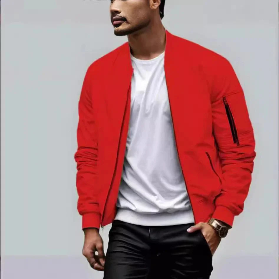 Man wearing a bright red bomber jacket over a white T-shirt and black pants with a gold watch