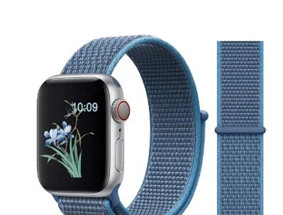Silver smartwatch with a blue woven nylon band displaying a floral watch face and 10:09 time