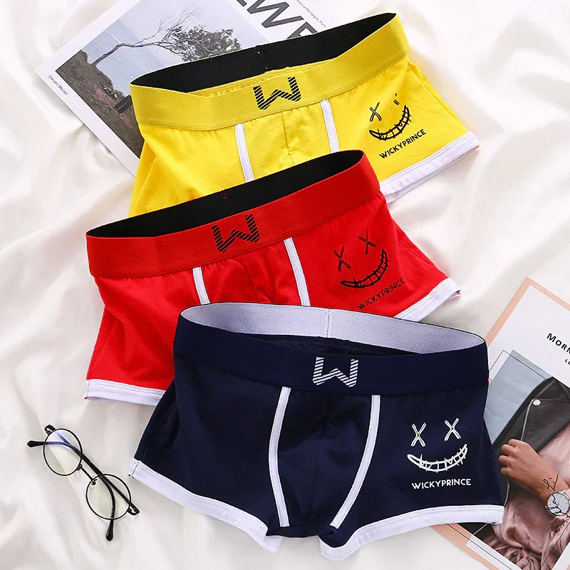 Colorful men's boxer briefs in yellow, red, and navy blue with smiley face and WICKYPRINCE logo