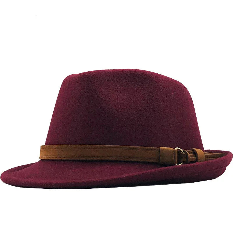 Burgundy fedora hat with a brown leather band and buckle detail on white background