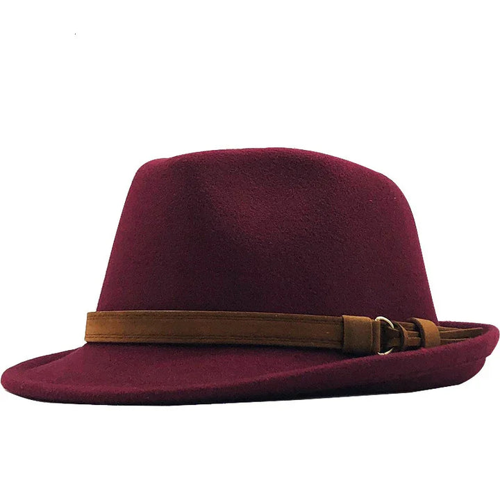Burgundy fedora hat with a brown leather band and buckle detail on white background
