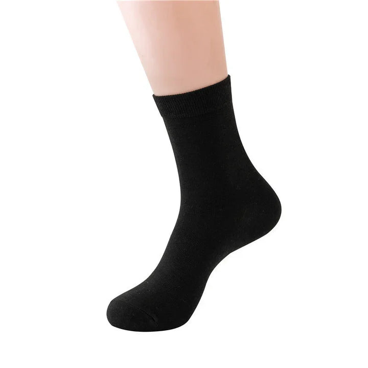 Black ankle sock on a mannequin foot against a white background