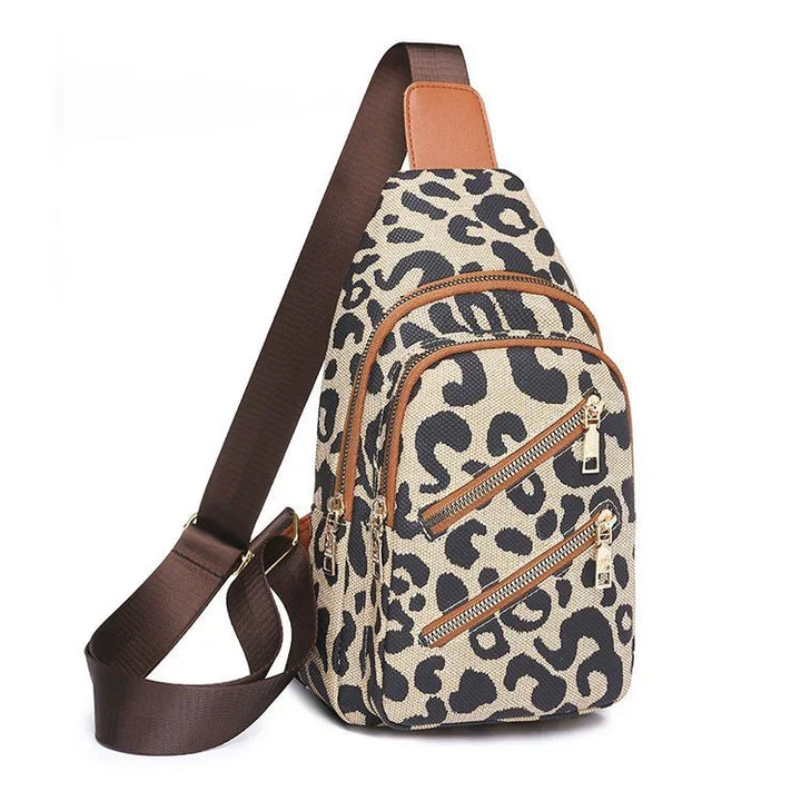 Leopard print crossbody sling bag with adjustable brown strap and multiple zippered pockets