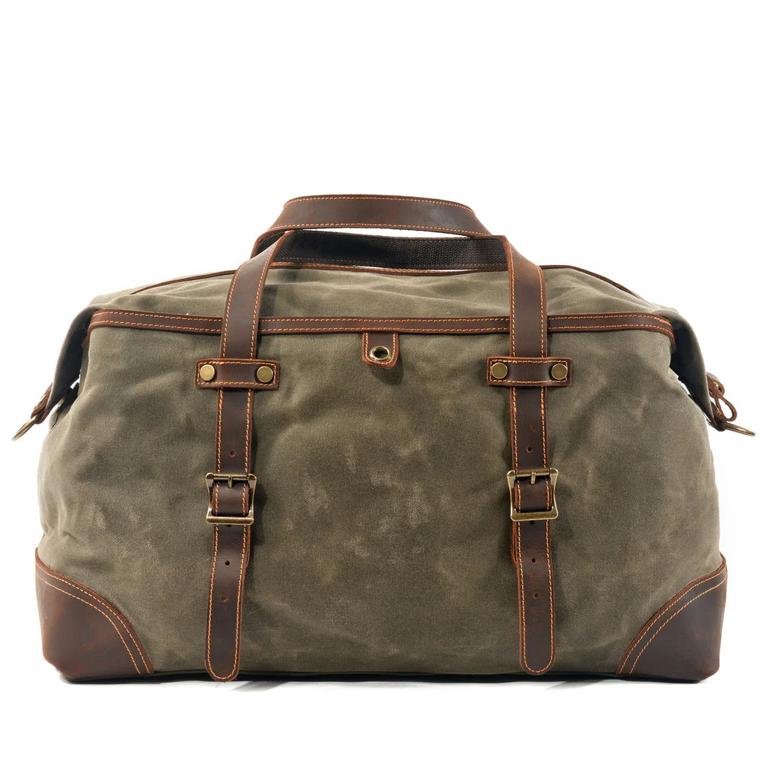 Khaki canvas and brown leather travel duffel bag with buckle straps and handles