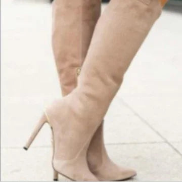 Beige suede high heel knee-high boots on a smooth sidewalk, stylish women's footwear