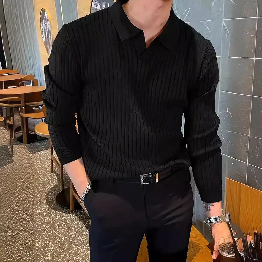 man wearing black ribbed long sleeve polo shirt and black pants in modern cafe interior