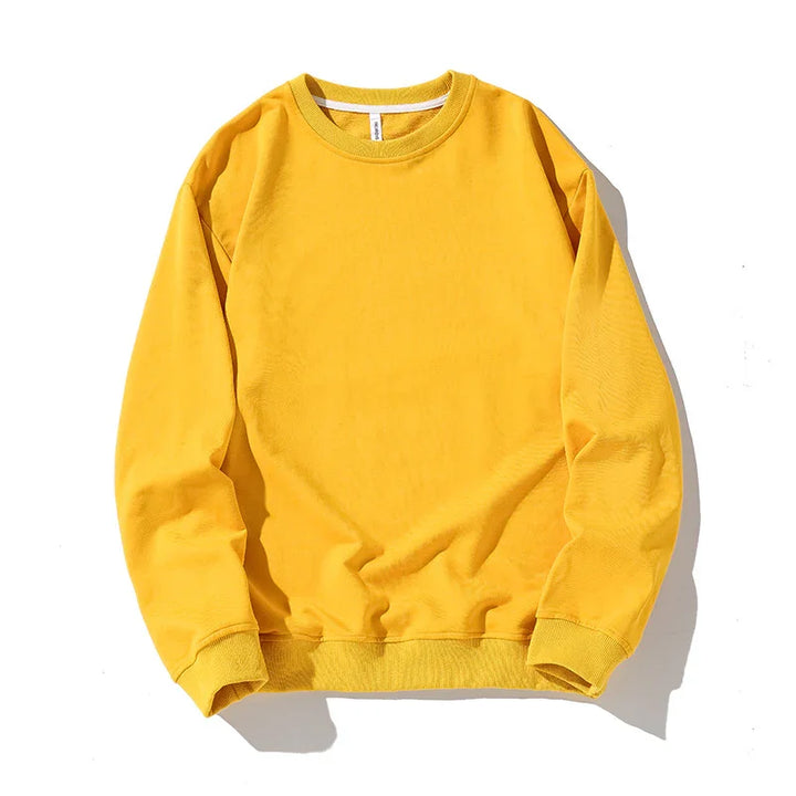 Bright yellow crewneck sweatshirt with long sleeves and ribbed cuffs on white background