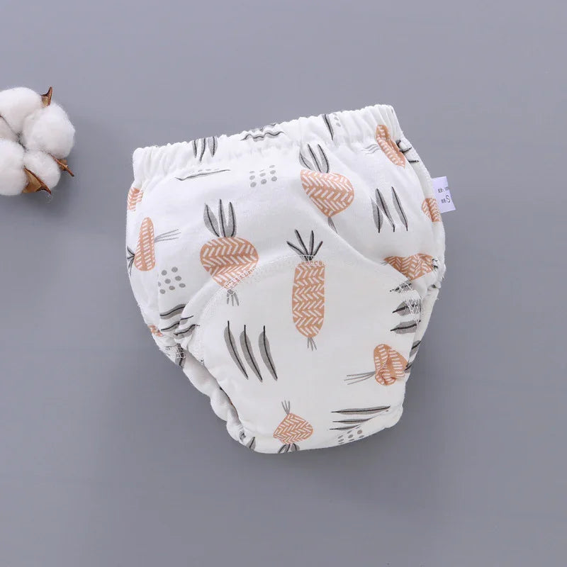 White baby diaper cover with orange and gray carrot print on gray background with cotton plant