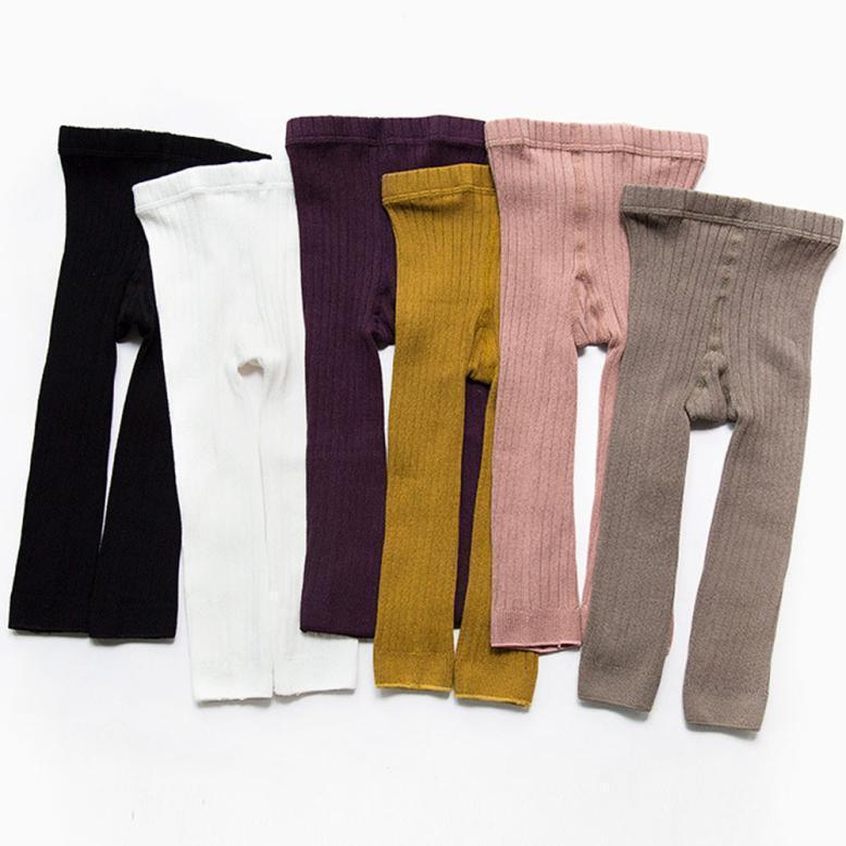 Set of ribbed knit baby leggings in black, white, purple, mustard, pink, and gray colors