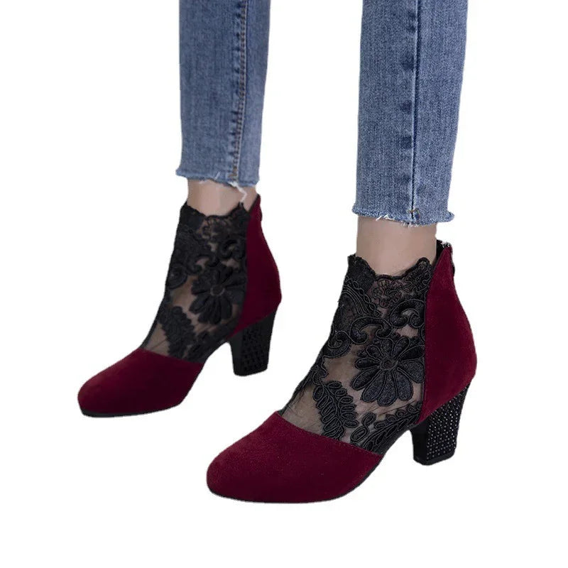 Women wearing burgundy suede heels with black floral lace ankle socks and blue jeans