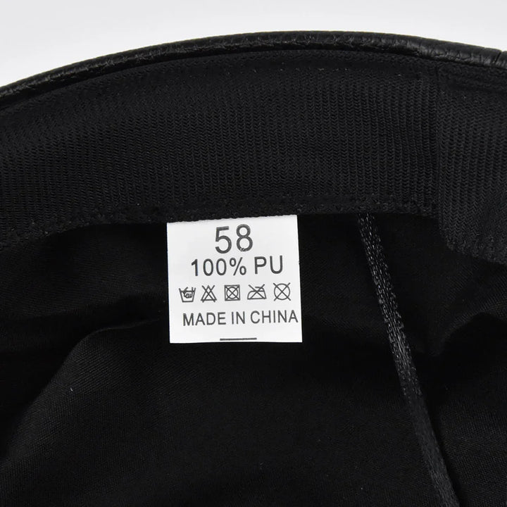 Clothing label inside black garment stating size 58, 100% PU material, made in China, with care symbols