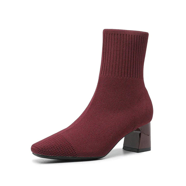 Burgundy knit sock ankle boot with block heel and textured toe on white background