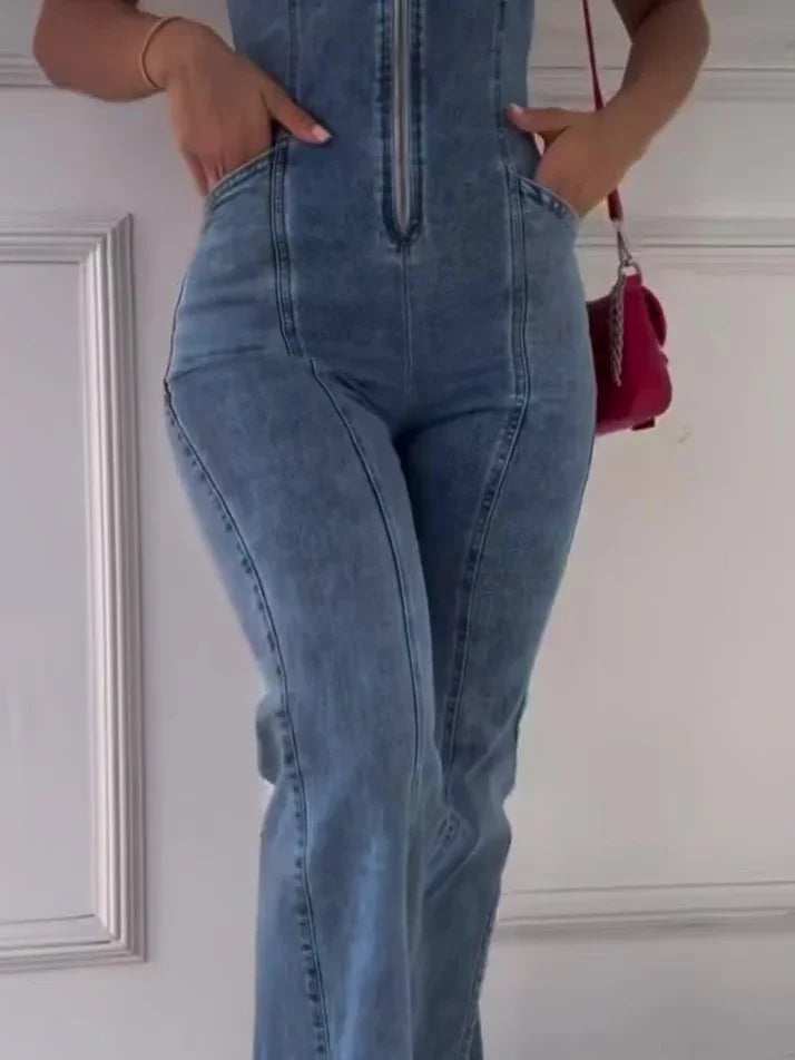 Woman wearing high-waisted blue denim jeans with front zipper and pockets holding red handbag