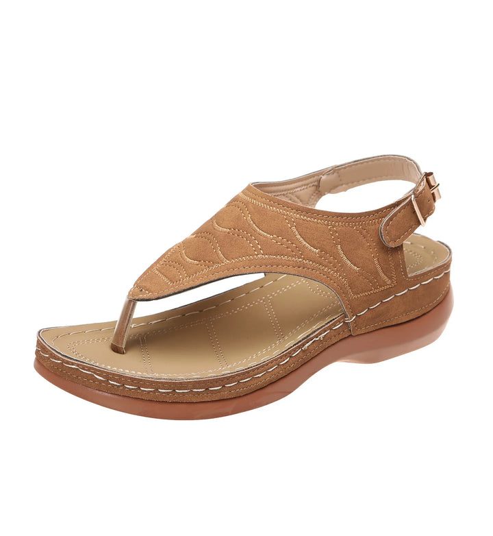 Brown leather thong sandal with stitched pattern and adjustable ankle strap on white background