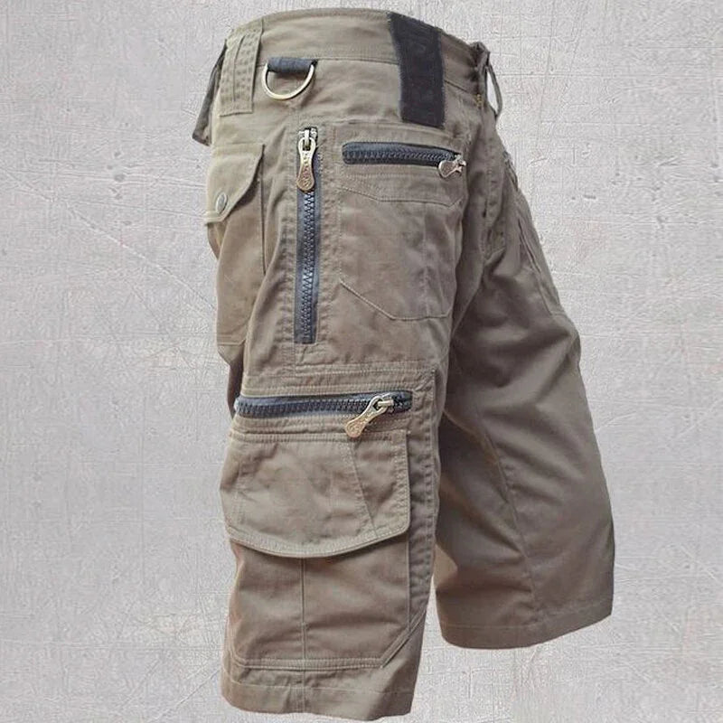 Brown casual cargo shorts with multiple zippered pockets and D-ring detail on side