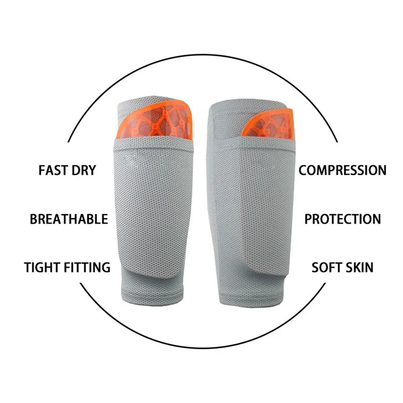 Gray and orange breathable compression shin guards with protective padding and fast dry fabric