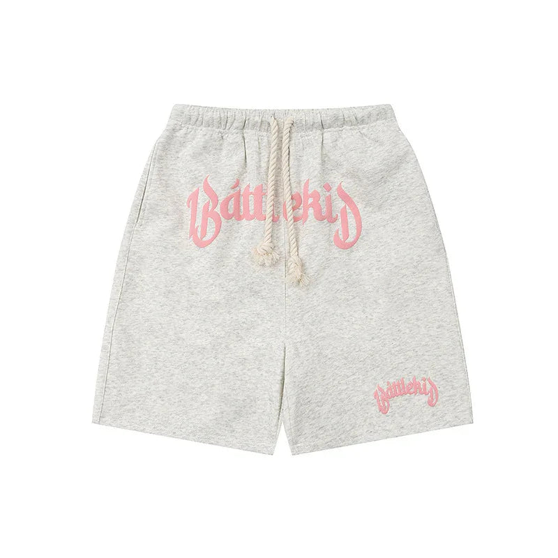 Light grey Battlekid shorts with pink logo, drawstring waist, casual streetwear style