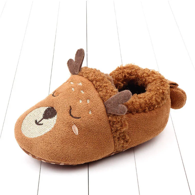 Brown fuzzy toddler slipper shaped like a sleeping deer with antlers and embroidered face