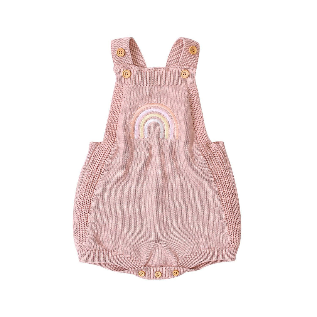 Pink knitted baby romper with straps, wooden buttons, and embroidered rainbow design