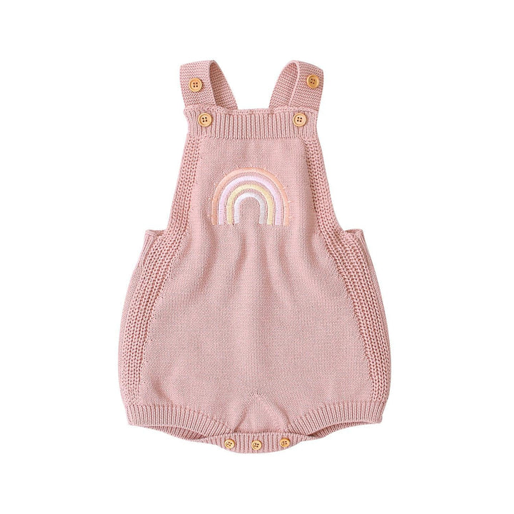 Pink knitted baby romper with straps, wooden buttons, and embroidered rainbow design