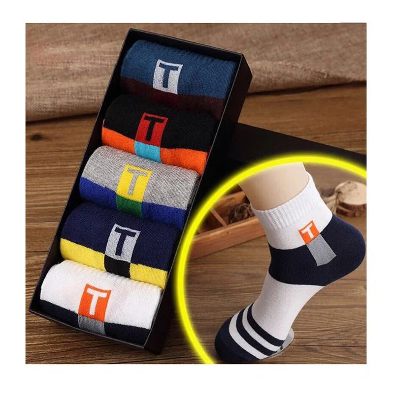 Box of colorful cotton socks with T logo and close-up of white striped ankle sock on foot