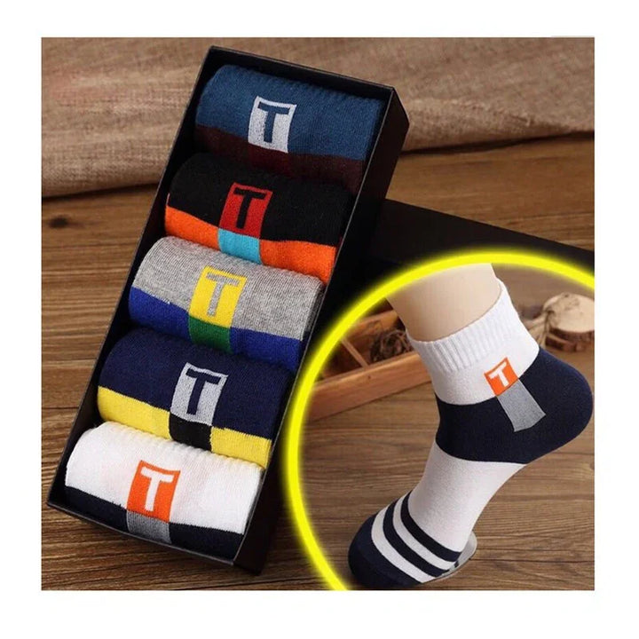 Box of colorful cotton socks with T logo and close-up of white striped ankle sock on foot