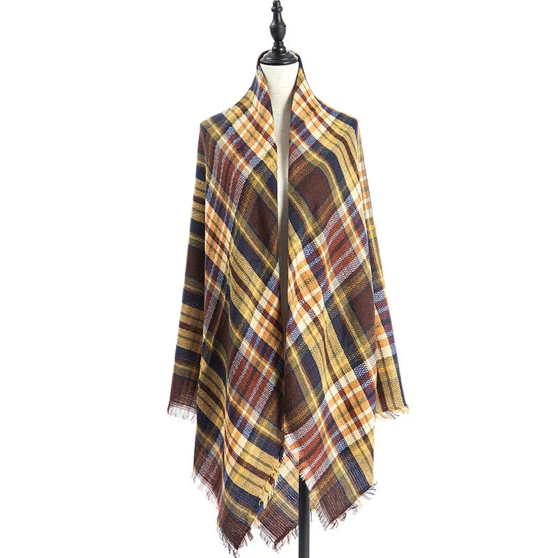 Fall plaid shawl in yellow, brown, blue, and white on mannequin with fringed edges