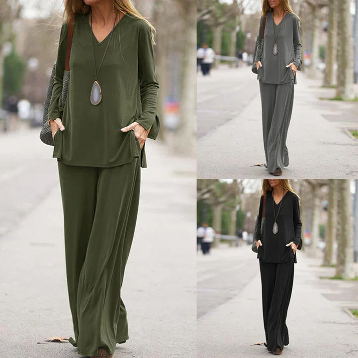 Woman wearing casual long-sleeve top and wide-leg pants outfit in olive green, gray, and black outdoors