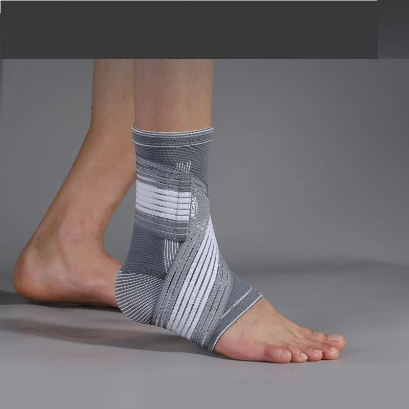 Gray and white ankle brace on foot for ankle support and injury recovery