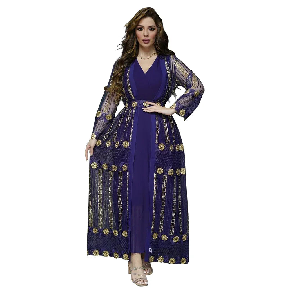 Woman wearing navy blue dress with sheer long embroidered jacket featuring gold floral and geometric patterns