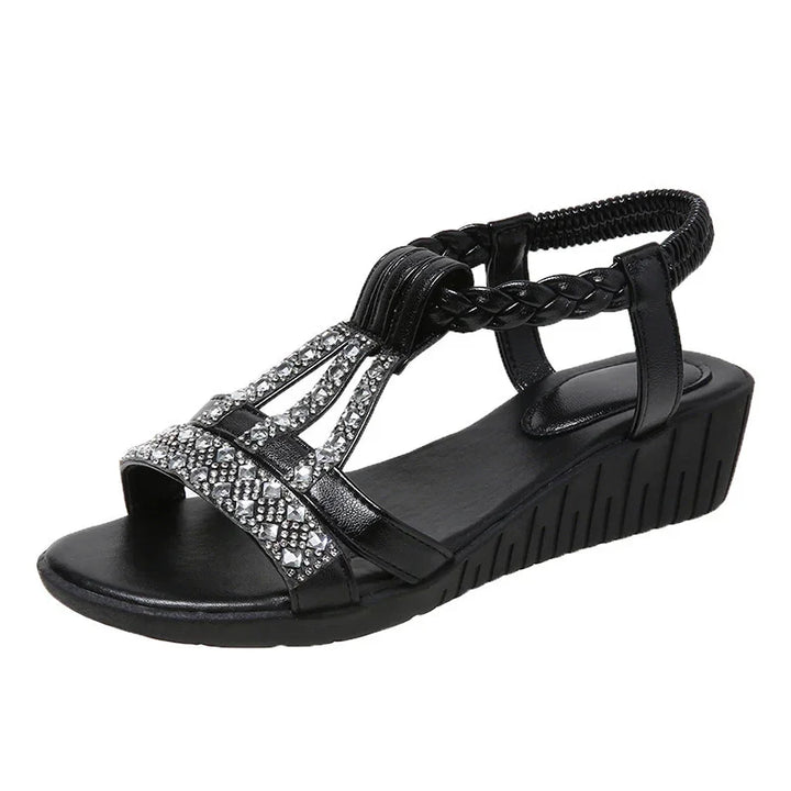 Black women's wedge sandal with braided strap and rhinestone embellishments on front straps