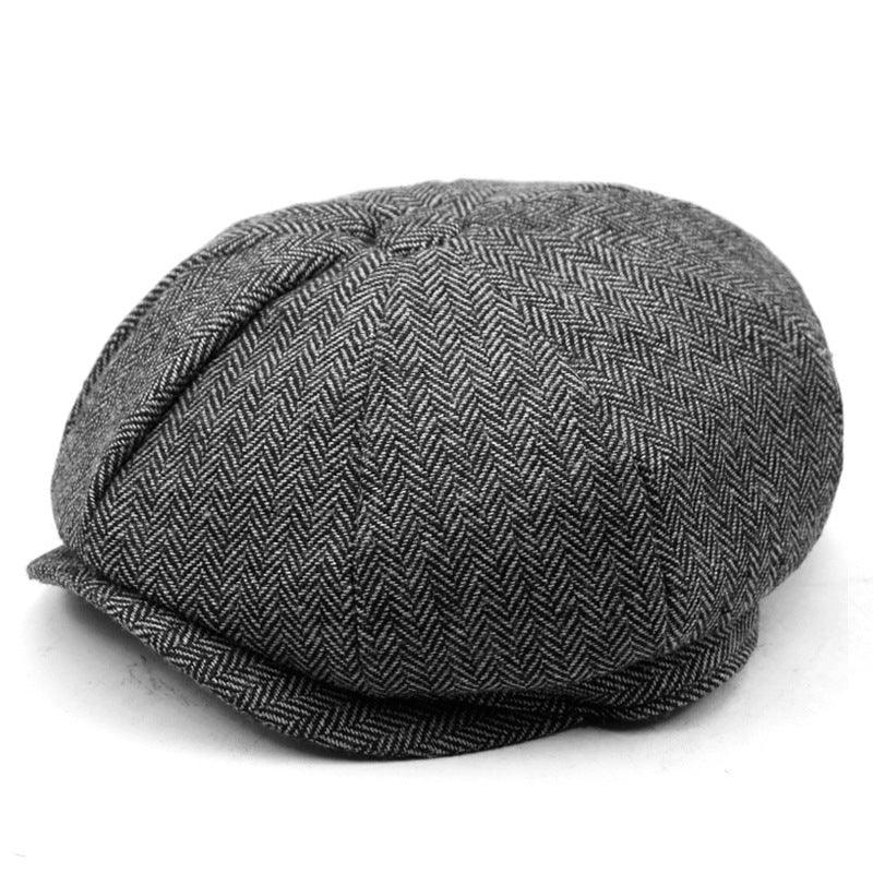 Gray herringbone flat cap with classic eight-panel design, styled vintage newsboy hat