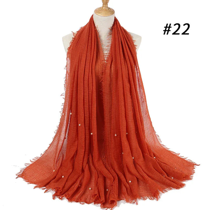 Rust orange lightweight scarf with small pearl accents on mannequin, style number 22
