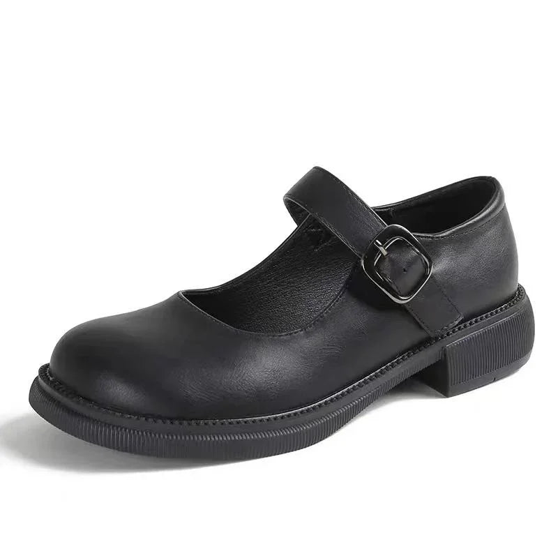 Black leather Mary Jane shoe with adjustable buckle strap and low chunky sole