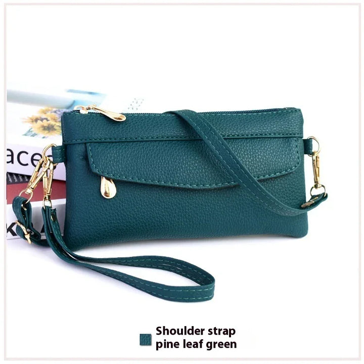 pine leaf green leather clutch purse with shoulder strap and gold zipper details