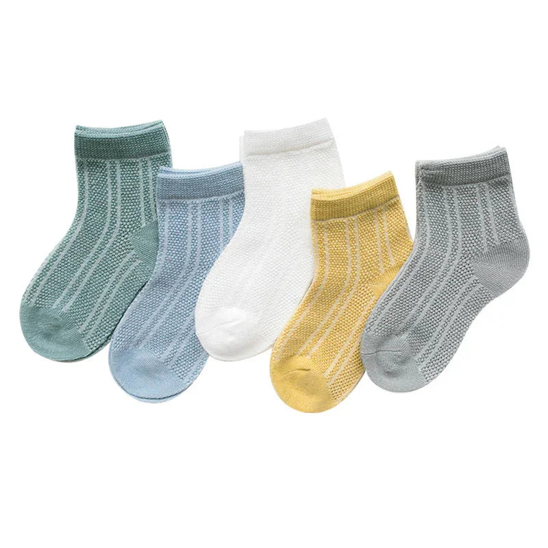Set of five knitted ankle socks in green, blue, white, yellow, and gray on white background