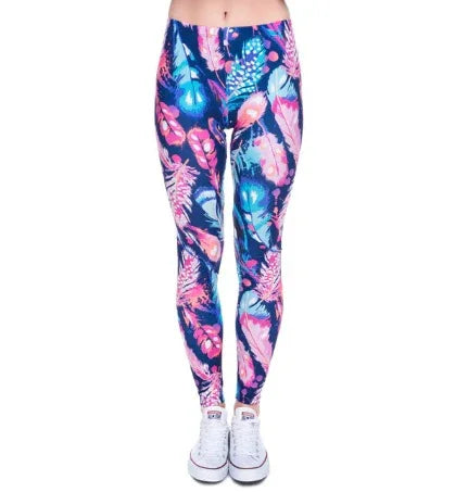 Woman wearing colorful feather print leggings with sneakers on white background