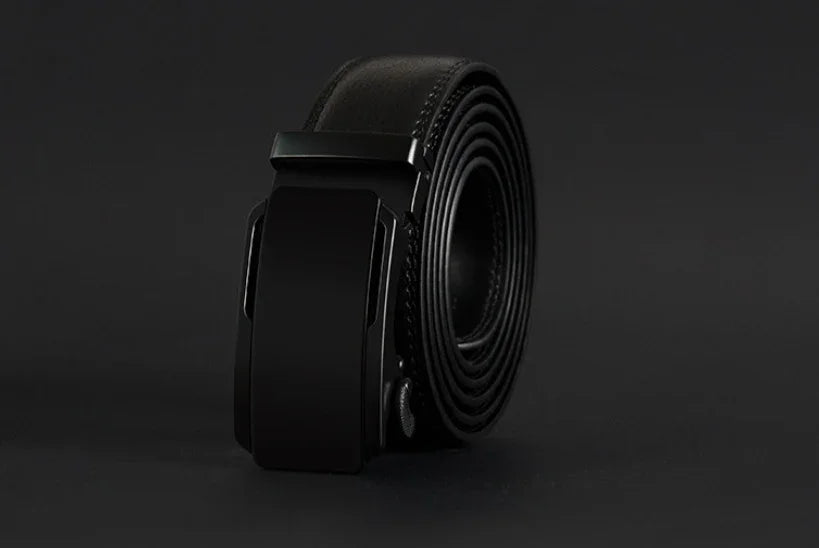 rolled black leather belt with matte black automatic buckle on dark background