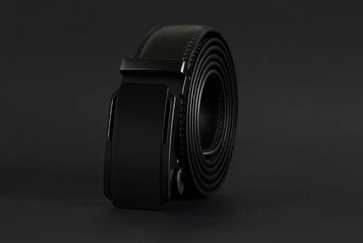 rolled black leather belt with matte black automatic buckle on dark background