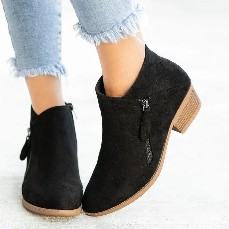 Black suede ankle boots with side zipper and low block heel worn with frayed hem light blue jeans