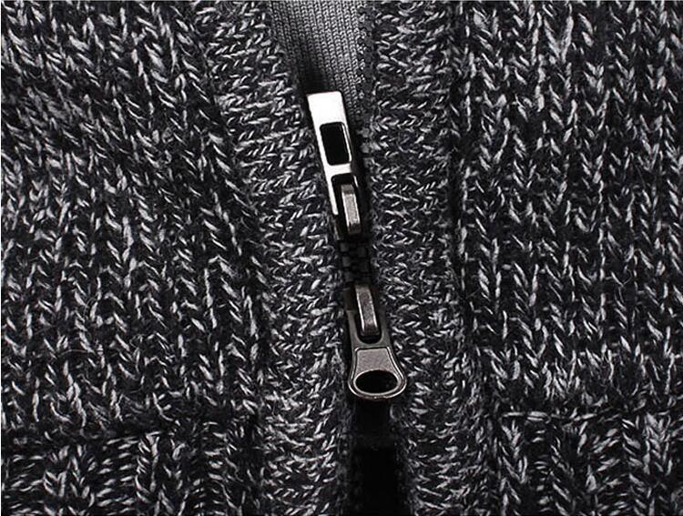 Close-up of black and white knitted fabric with a silver zipper in the center