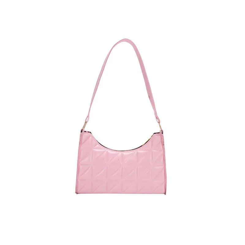Light pink shoulder handbag with quilted pattern and short strap on white background
