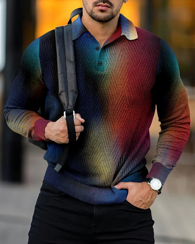 Man wearing multicolor gradient knit polo sweater with buttoned collar, black pants, wristwatch, and backpack strap