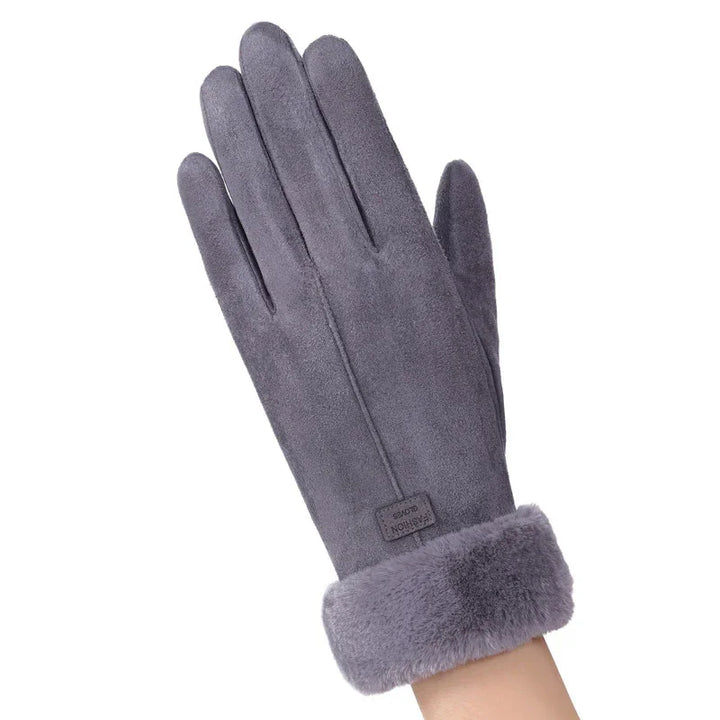Gray suede winter glove with plush fur cuff on a raised hand