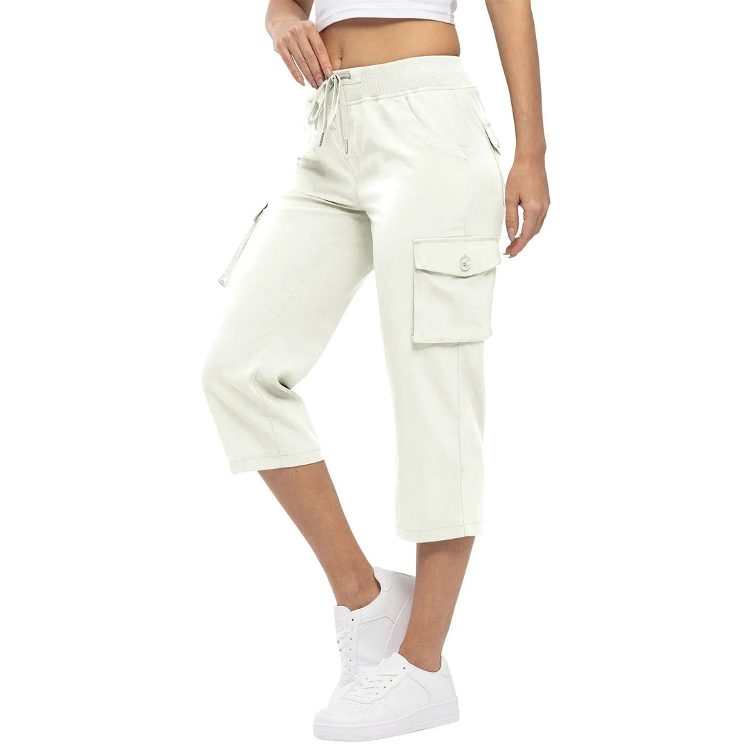 Woman wearing beige cargo capri pants with drawstring waist and white sneakers