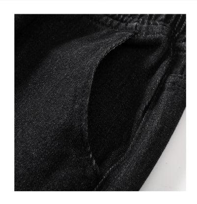 Close-up of black fabric pocket with visible stitching and elastic waistband detail
