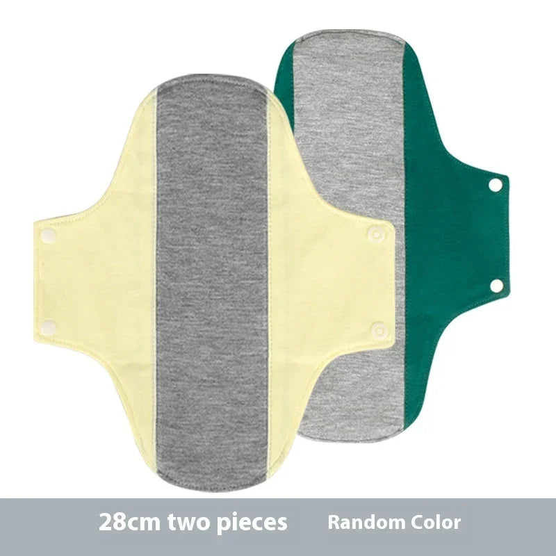 Two 28cm reusable cloth panty liners in grey with yellow and green sides, snap closure