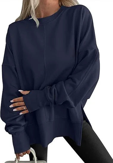 Woman wearing oversized navy blue sweatshirt with long sleeves and crew neck, paired with black leggings