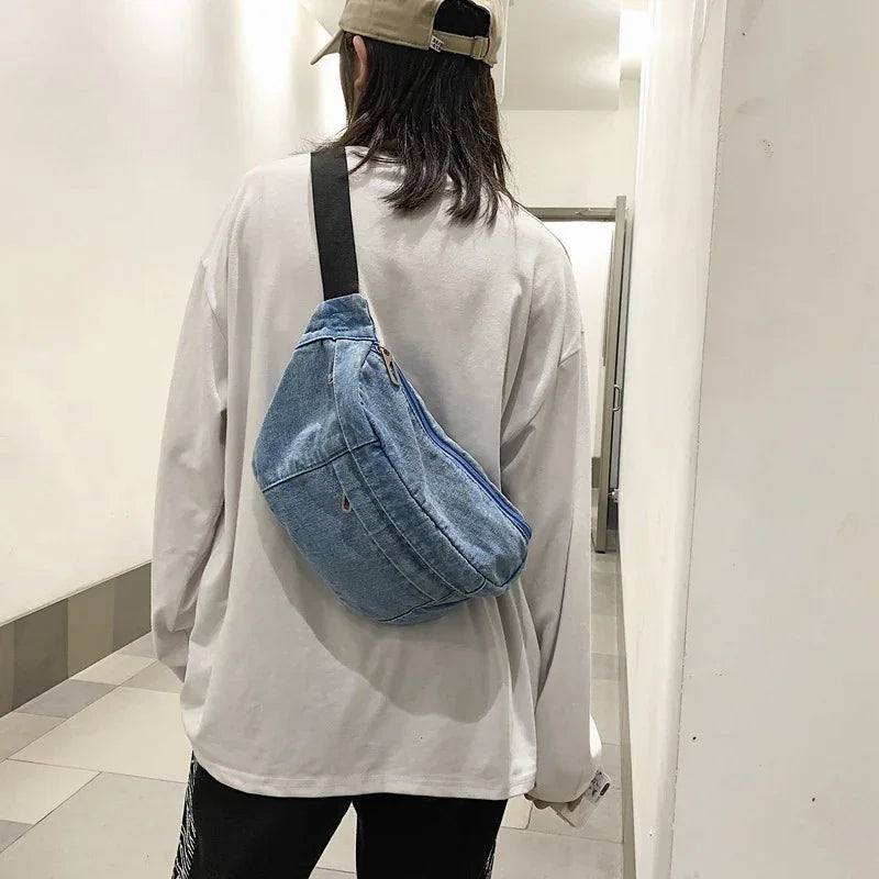 Person wearing beige cap and white long-sleeve shirt with blue denim sling bag in hallway