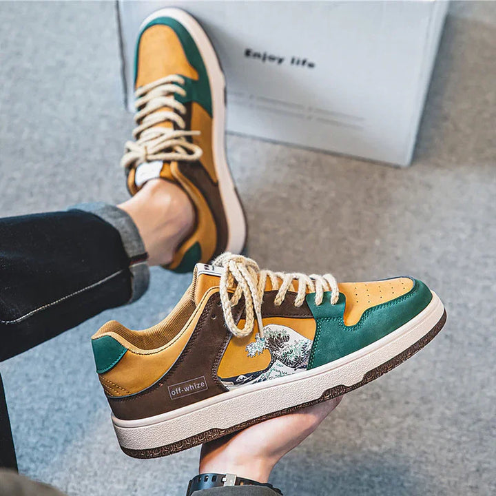 Yellow, green, and brown casual sneakers with wave graphic and 'off-whize' label, styled with rolled black jeans